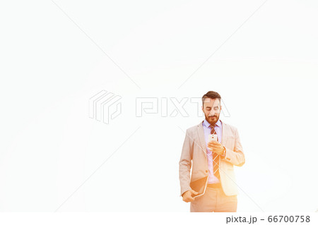 Serious male CEO is reading resume specialists before interview 66700758