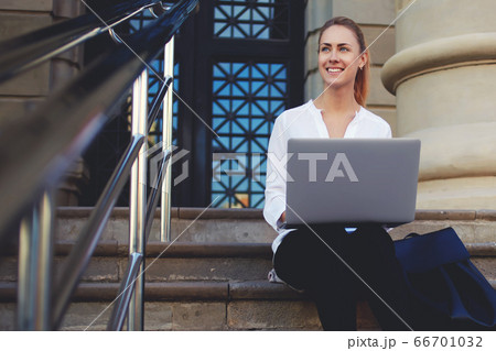 young woman office worker is having mobile phone conversation during work break 66701032