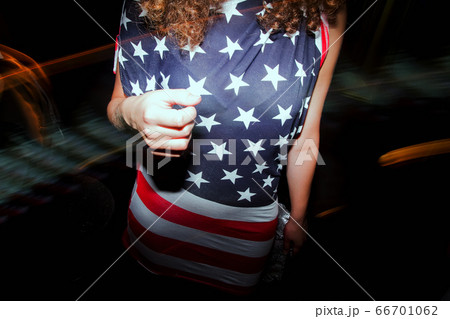 girl wearing american flag t-shirt standing in disco 66701062