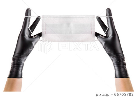 Hand in black gloves wearing disposable face mask Hand in black gloves wearing disposable face mask 66705785