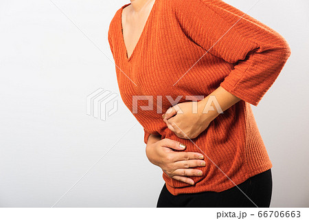 Woman have stomach ache holds hands on abdomen, Woman have stomach ache holds hands on abdomen, 66706663