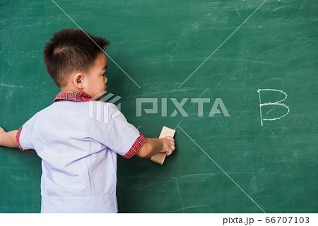 Child boy kindergarten in student uniform wiping Child boy kindergarten in student uniform wiping 66707103