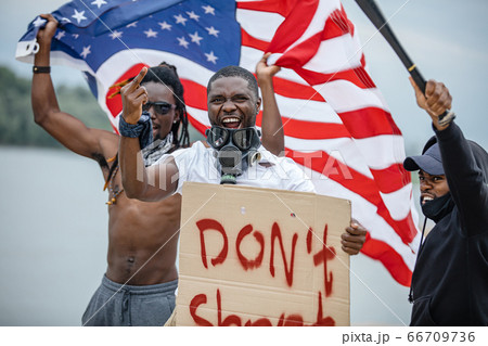 Black lives matter protests go global. three afroamerican people with posters in the street Black lives matter protests go global. three afroamerican people with posters in the street 66709736