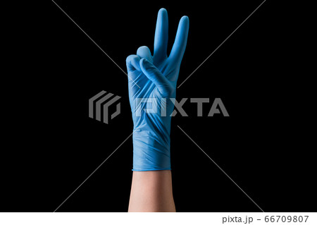 Doctor's hand in medical gloves showing two Doctor's hand in medical gloves showing two 66709807