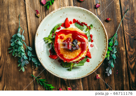 Sweet breakfast pancakes with berries and sauce Sweet breakfast pancakes with berries and sauce 66711176