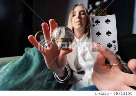 Woman in business suit holding crystal ball and six spade Woman in business suit holding crystal ball and six spade 66713150