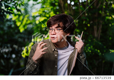 Male scientist hiding in the thicket. Nature protection concept. Male scientist hiding in the thicket. Nature protection concept. 66713539