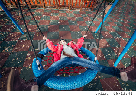 Happy child girl on swing. Little kid playing in the autumn pack. Happy child girl on swing. Little kid playing in the autumn pack. 66713541
