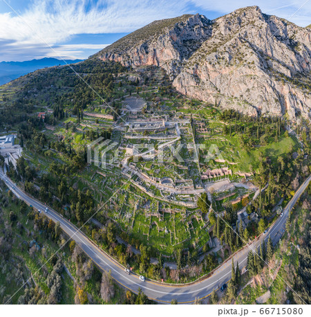 Aerial view of antique Theatre and Apollo Temple in Delphi, Greece at sunrise, famous archaeological site in Greece, Morning fog over mountains, hoarfrost on roofs Aerial view of antique Theatre and Apollo Temple in Delphi, Greece at sunrise, famous archaeological site in Greece, Morning fog over mountains, hoarfrost on roofs 66715080