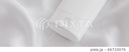 Blank label cosmetic container bottle as product mockup on white silk background Blank label cosmetic container bottle as product mockup on white silk background 66720076