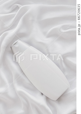 Blank label cosmetic container bottle as product mockup on white silk background 66720635