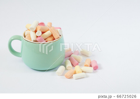 Colorful marshmallow in light green cup isolated on white background with copy space 66725026
