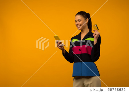 Lady buying online with a credit card and smart 66728622
