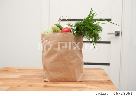 Contactless product delivery by the door. Food donation package vegetables to help the poor. Donat box with foodstuffs 66728961