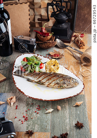 Grilled trout fish with salad and lemon 66729543