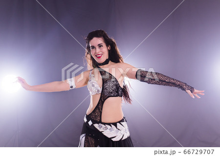 Spirituality dance. Beautiful sexy woman with luxury glossy eastern make-up dancing tribal fusion. Belly dance. 66729707