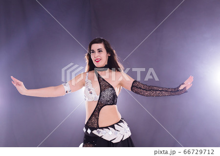 Spirituality dance. Beautiful sexy woman with luxury glossy eastern make-up dancing tribal fusion. Belly dance. 66729712