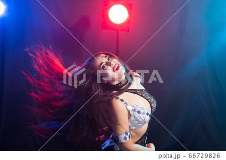 Young woman dancing in Tribal Fusion style. Belly dance on the stage. 66729826