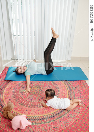 Young mother exercising at home Young mother exercising at home 66729889