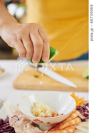Woman making dipping sauce Woman making dipping sauce 66730069