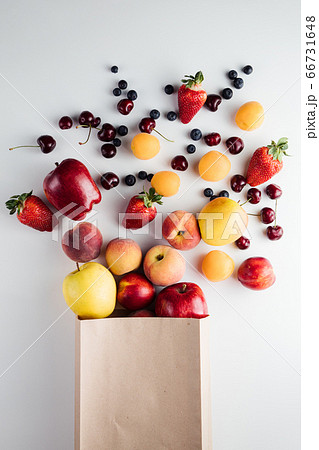 Healthy vegetarian vegan clean food in paper bag fruits on white background 66731648