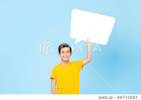 Waist up portrait of smiling cute Asian boy holding speech bubble 66731683