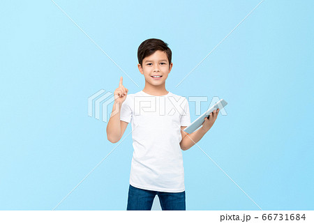 Cute mixed race boy holding tablet with pointing gesture 66731684