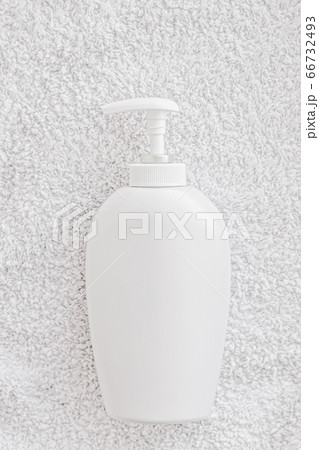 Blank label cosmetic container bottle as product mockup on white towel background Blank label cosmetic container bottle as product mockup on white towel background 66732493