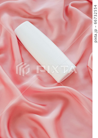 Blank label cosmetic container bottle as product mockup on pink silk background 66732554