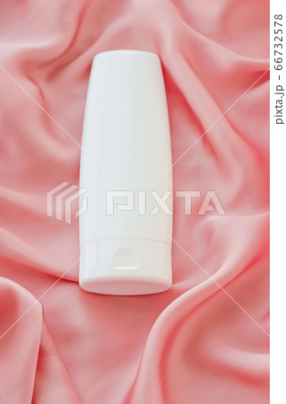 Blank label cosmetic container bottle as product mockup on pink silk background 66732578