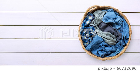 Clothes in laundry basket on white wooden Clothes in laundry basket on white wooden 66732696
