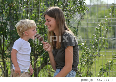 A Boy With Cochlear Implants Eating Ice Cream 66733311