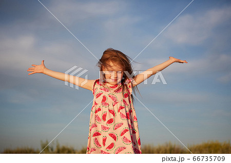 Smiling beautiful girl having fun on the beach. Portrait of happy cute little girl with copy space. Portrait of kid during summer Smiling beautiful girl having fun on the beach. Portrait of happy cute little girl with copy space. Portrait of kid during summer 66735709