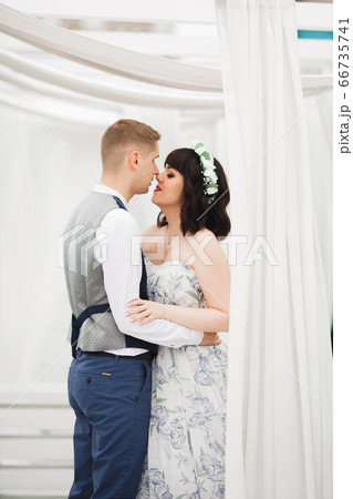 Gorgeous happy couple standing close to each other and looking in eyes 66735741