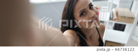 Girl sitting on bed and reaches out to camera Girl sitting on bed and reaches out to camera 66736122