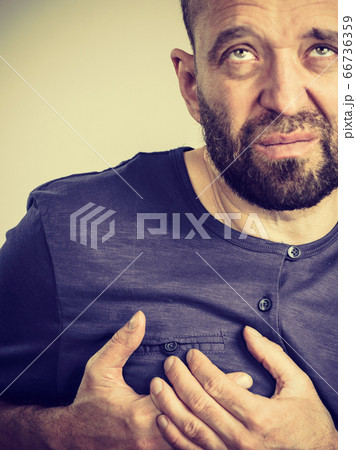 Man having heart pain attack 66736359
