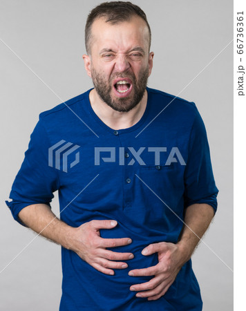 Man feeling stomach ache pain Man feeling stomach ache pain 66736361