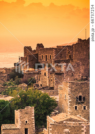 Tower houses in Vathia at sunset Greece Mani 66737254