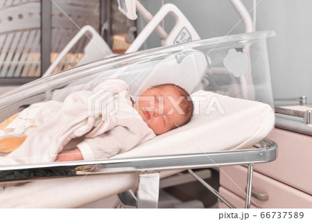 Newborn baby sleeping in the hospital bed 66737589
