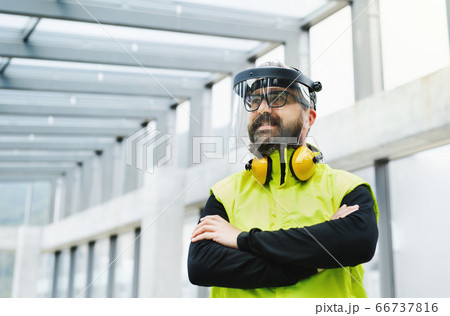 Portrait of worker with protective shield standing at the airport. 66737816