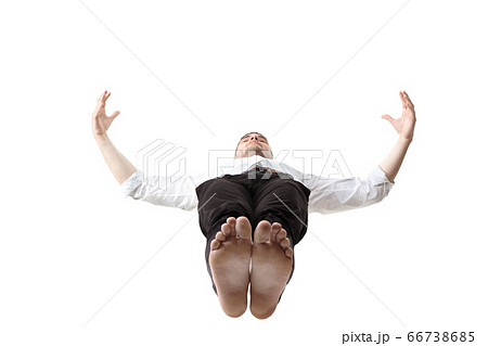 Mid-air beauty. Full length studio shot of attractive young man hovering in air and keeping eyes closed 66738685