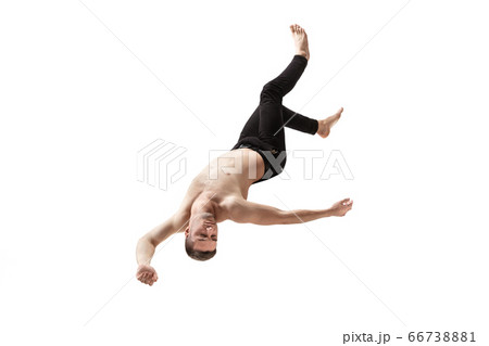 Mid-air beauty. Full length studio shot of attractive young man hovering in air and keeping eyes closed 66738881