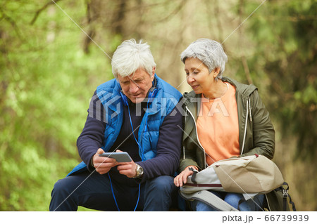 Senior Couple Resting during Hike in Forest Senior Couple Resting during Hike in Forest 66739939