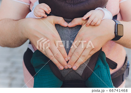 Young father and his baby girl in a baby carrier. 66741468