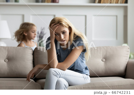 Tired nanny does not cope with capricious little kid girl Tired nanny does not cope with capricious little kid girl 66742231