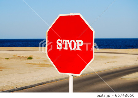 Stop sign on a sea coast Stop sign on a sea coast 66743050