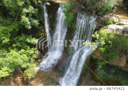 Idyllic rain forest waterfall, stream flowing in the lush green forest. Idyllic rain forest waterfall, stream flowing in the lush green forest. 66745421