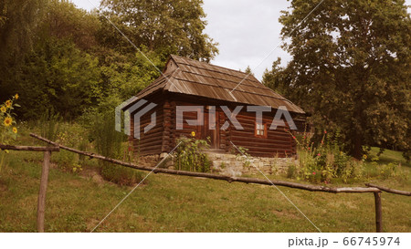 Log small building on the brick foundation in the forest. Log small building on the brick foundation in the forest. 66745974