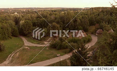 Road crosses the village in the forest. Road crosses the village in the forest. 66746145