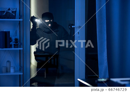 Criminal trying to break into apartment or office to steal Criminal trying to break into apartment or office to steal 66746729